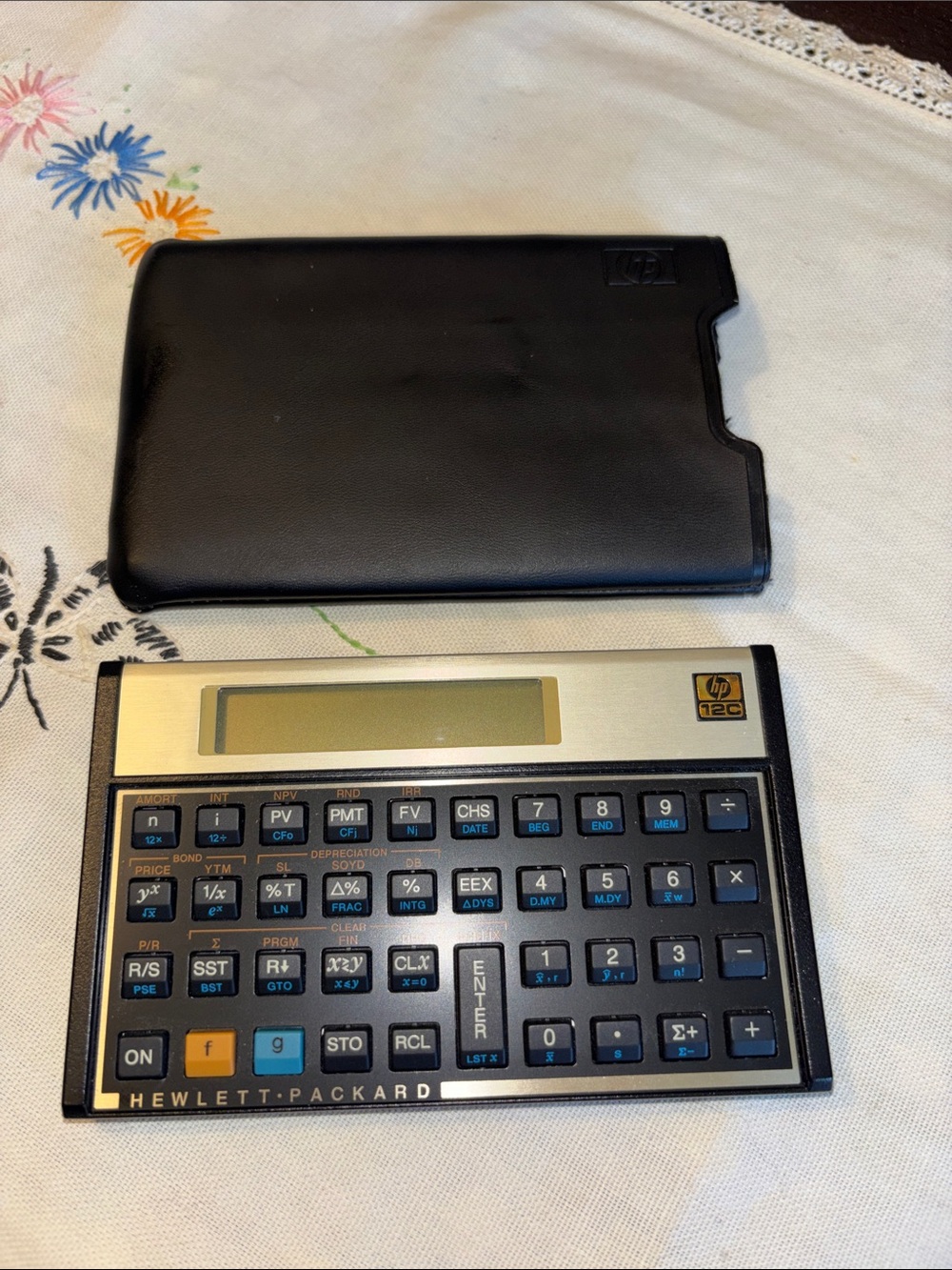 EUC VINTAGE HP 12C Financial Calculator sitting next to its original black case.